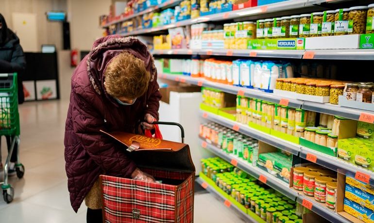 A woman in a supermarket browses goods