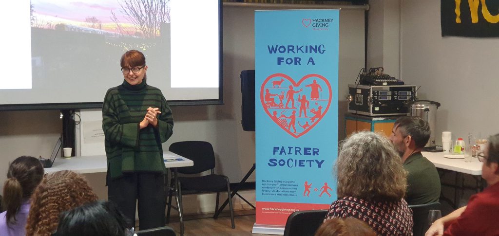 Martyna in front of the Working for a Fairer Society banner