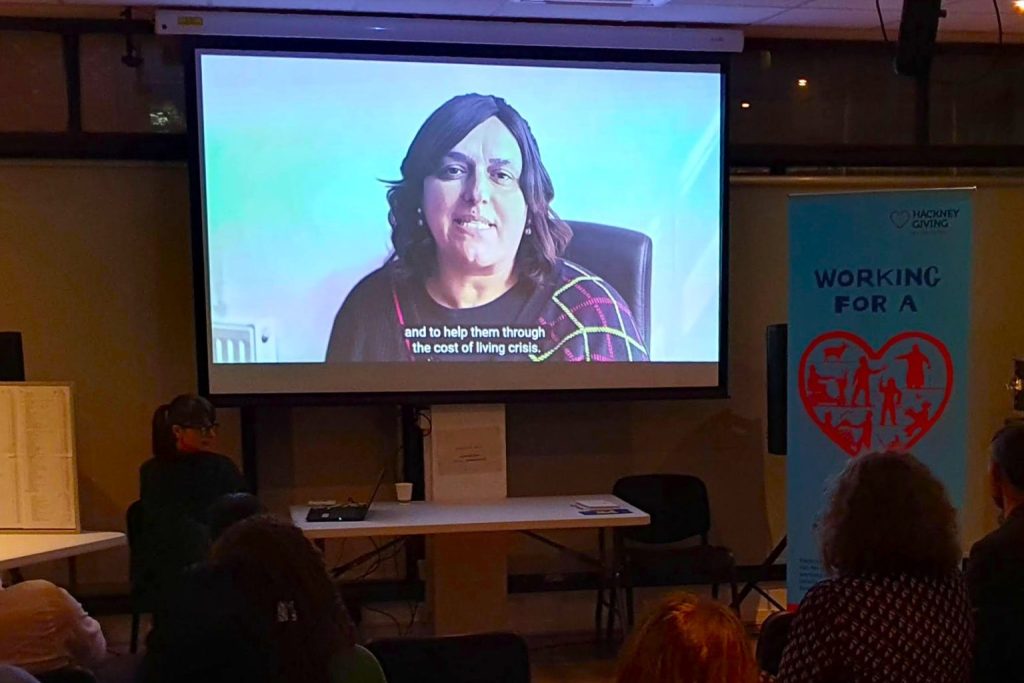 Audience watching the Hackney Giving 2024 film at an event