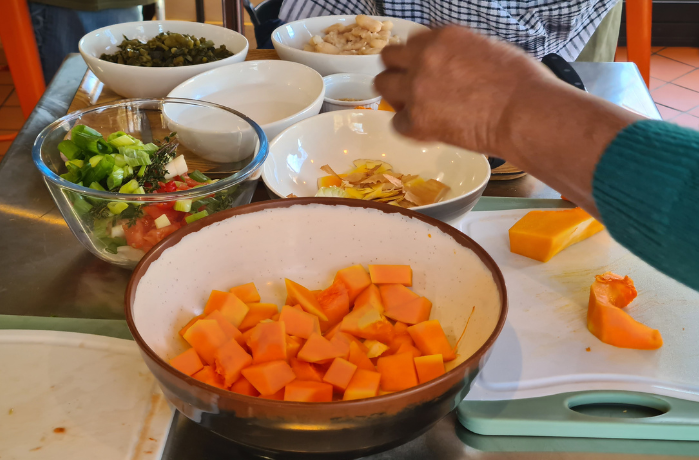 Preparing food at a Hackney Giving funded project about healthy living