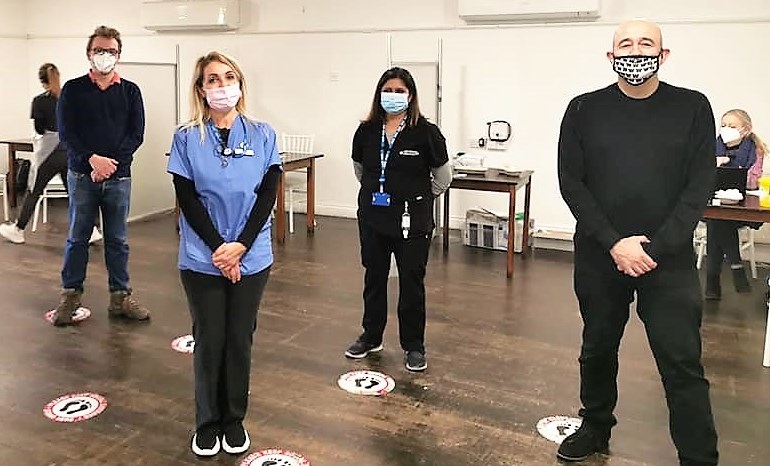 People standing apart and wearing masks during the COVID-19 pandemic